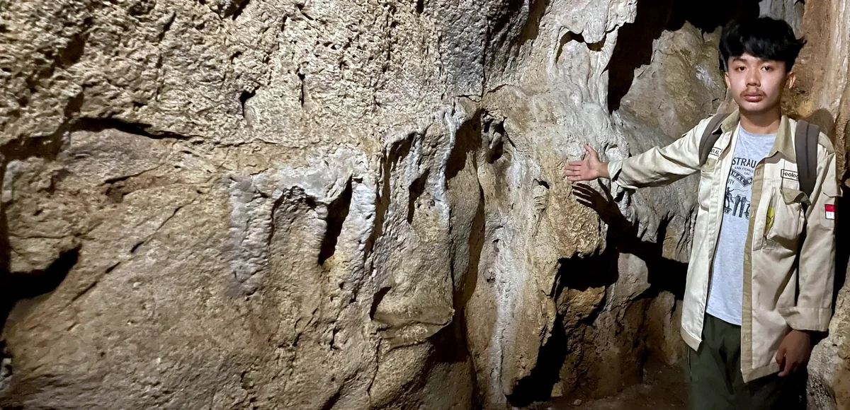 Human-scale view of a limestone cave wall and passage