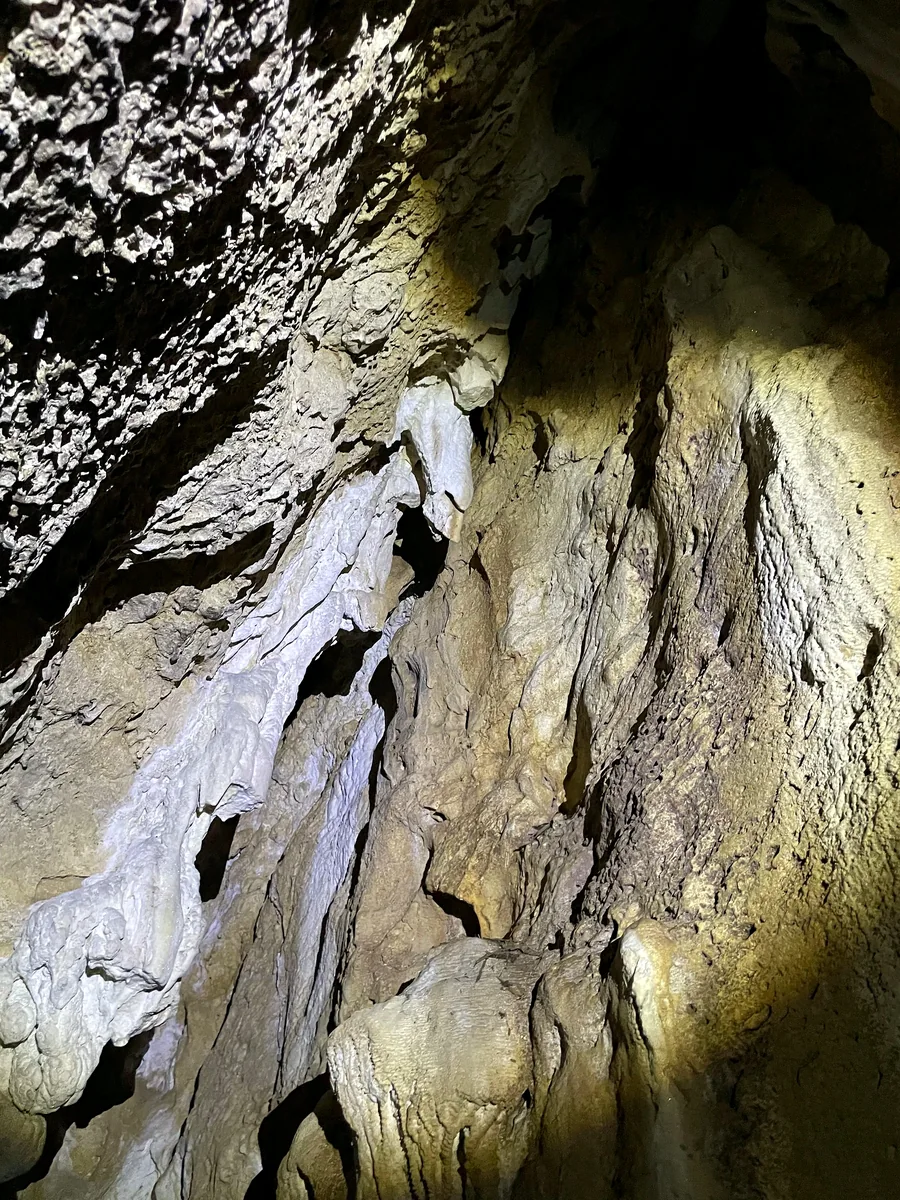 Sheet-like secondary carbonate deposits on cave wall